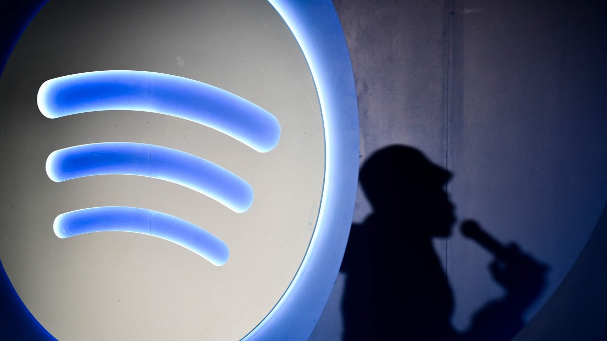 Spotify&#039;s Artificial Intelligence DJ announcer, Xavier X Jernigan&#039;s shadow, is pictured as he attends the presentation of the latest Spotify tool in Mexico City, Mexico, July 17, 2024. (AFP Photo)