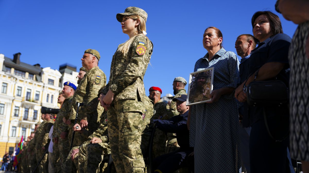 Ukrainian soldiers and family members of the fallen take part in a ceremony on Independence Day in Sophia Square, Kyiv, Ukraine, Aug. 24, 2025. (AP Photo)