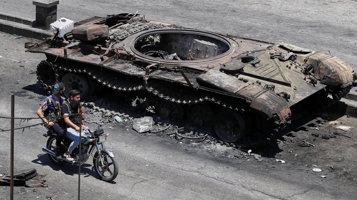 Druze militiamen ride a motorcycle past a destroyed military vehicle following last week&#039;s clashes in Suwayda, Syria, July 25, 2025. (AP Photo)