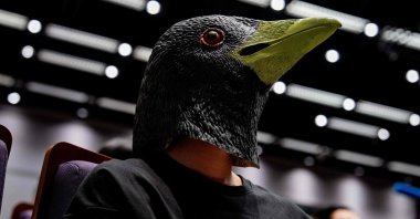 A participant wears a bird-themed mask as he watches the Hong Kong Bird Watching Society’s bird call competition at the University of Hong Kong on August 23, 2025. (AFP Photo)
