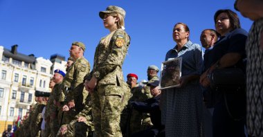 Ukrainian soldiers and family members of the fallen take part in a ceremony on Independence Day in Sophia Square, Kyiv, Ukraine, Aug. 24, 2025. (AP Photo)