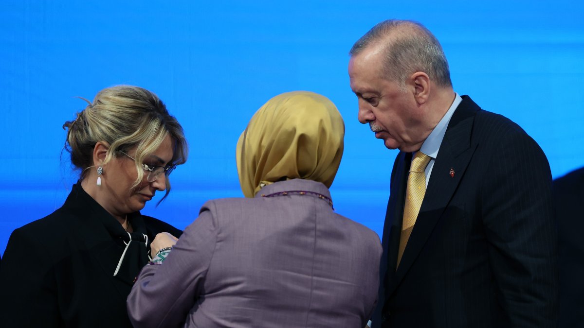 President Recep Tayyip Erdoğan and a Justice and Development Party (AK Party) official attach a party pin to the lapel of Yasemin Fazlaca, a newly joined member from the opposition, during a ceremony, Ankara, Türkiye, Aug. 14, 2025. (IHA Photo)