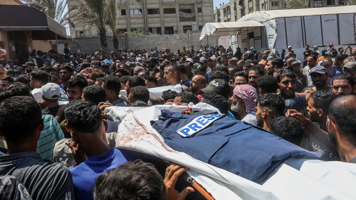 People attend a funeral in the courtyard of Nasser Hospital for the journalists killed in the Israeli attack, Khan Younis, southern Gaza, Palestine, Aug. 25, 2025.
