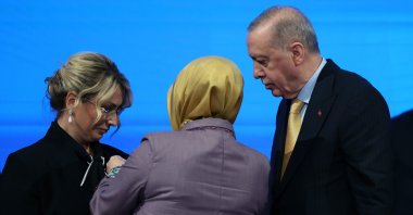 President Recep Tayyip Erdoğan and a Justice and Development Party (AK Party) official attach a party pin to the lapel of Yasemin Fazlaca, a newly joined member from the opposition, during a ceremony, Ankara, Türkiye, Aug. 14, 2025. (IHA Photo)