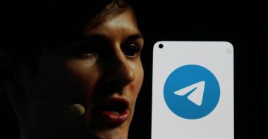 The Telegram app logo is displayed on a smartphone screen, with Telegram founder Pavel Durov in the background, in Bandung, Indonesia, Aug. 25, 2024. (Shutterstock Photo)