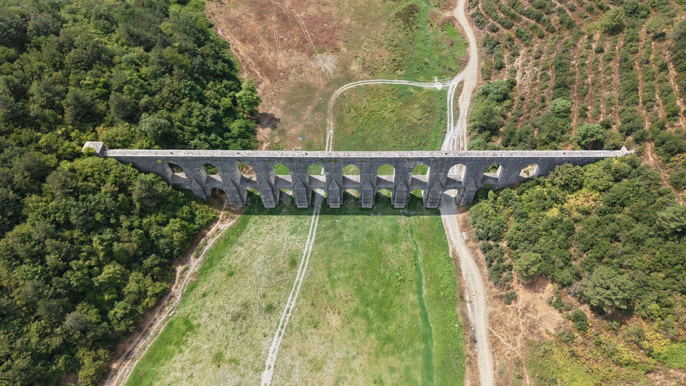 Aerial view of a nearly dried dam showing low water levels amid summer heat in Istanbul, Türkiye, Aug. 6, 2025. (DHA Photo)