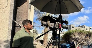 Palestinian cameraman Hussam al-Masri, who was a contractor for Reuters and killed in Israeli strikes on Nasser hospital, stands next to his camera as he works at Nasser hospital, in Khan Younis in the southern Gaza Strip, in this undated picture. (Reuters File Photo)