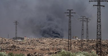 Smoke rising from the town of Al-Mazra&#039;a as a result of burning houses following clashes between Bedouin tribes and local Druze factions, in the Suwayda countryside in southern Syria, July 18, 2025. (EPA File Photo)
