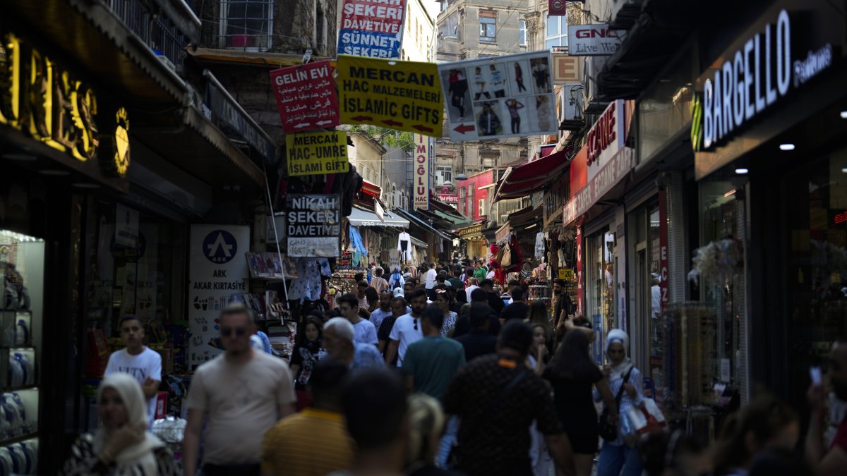 People walk along a street market at Eminönü commercial area in Istanbul, Aug. 23, 2023. (AP Fıle Photo)
