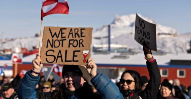A protester holds a sign reading &quot;We are not for sale&quot; in front of the U.S. consulate in Nuuk, Greenland, March 15, 2025. (AFP Photo)