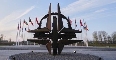 Flags of Alliance members flap in the wind prior to a meeting of NATO foreign ministers at NATO headquarters in Brussels, Belgium, April 3, 2025. (AP Photo)