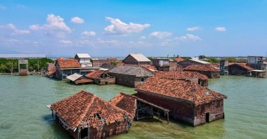 This photo shows an aerial view of abandoned and partially submerged houses due to land loss from climate change at Bedono village in Demak, Central Java, Indonesia, July 30, 2025. (AFP Photo)