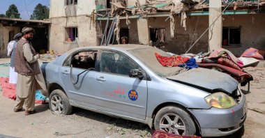 Afghan men stand near a damaged house after overnight aerial strikes in the Soor Kakh area at Lahori Village in the Spera district of Khost Province, Afghanistan, Aug. 28, 2025. (AFP Photo)