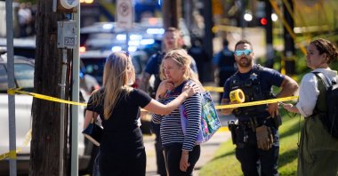 Loved ones console each other after a shooting at Annunciation Church, which is also home to an elementary school, Minneapolis, U.S., Aug. 27, 2025. (Reuters Photo)