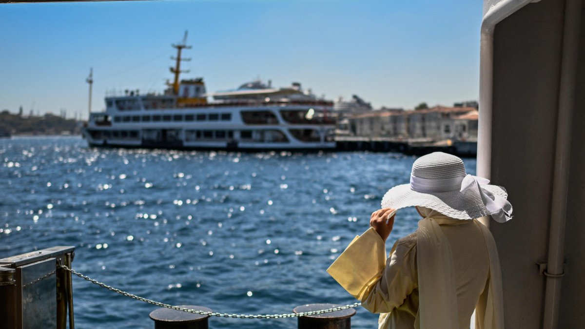 A passenger waits on the Paşabahçe ferryboat docked at Kabataş port in Istanbul, Türkiye, Aug. 21, 2025. (AFP Photo)