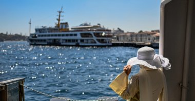 A passenger waits on the Paşabahçe ferryboat docked at Kabataş port in Istanbul, Türkiye, Aug. 21, 2025. (AFP Photo)