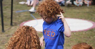 A family attends a performance during the Red Head Days festival in Tilburg, Netherlands, Aug. 30, 2025. (AP Photo)