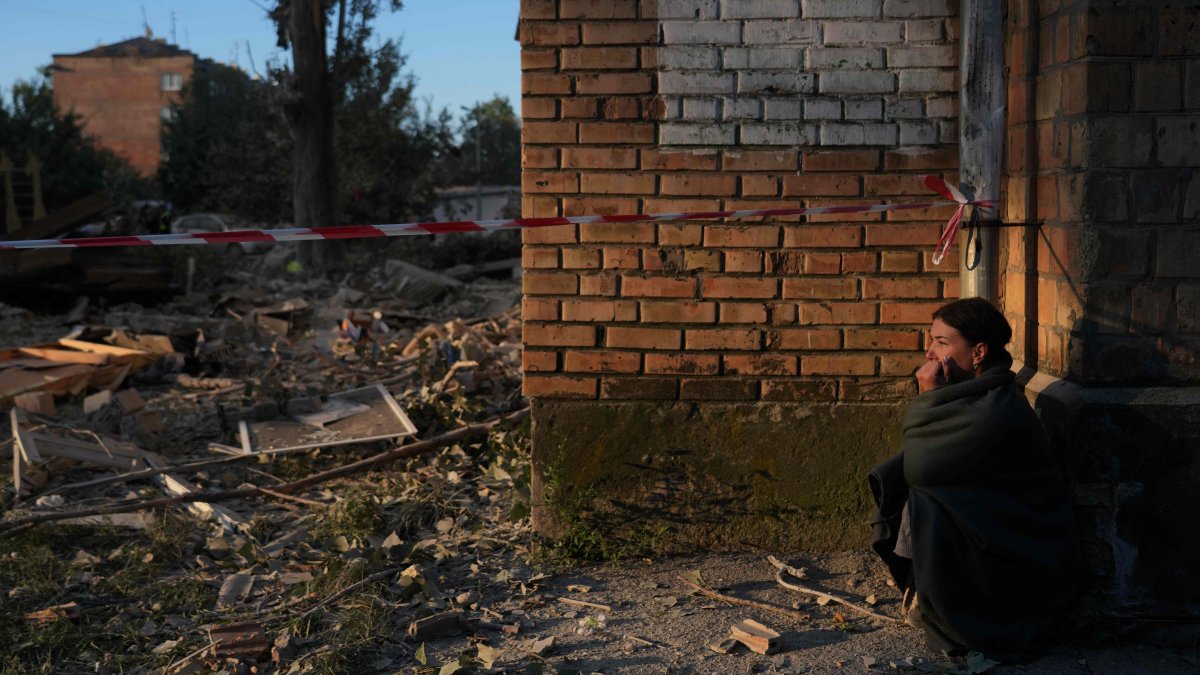A local sits next to a heavily damaged residential building following a large-scale Russian drone and missile attack on Kyiv, Ukraine, Aug. 28, 2025. (AFP Photo)