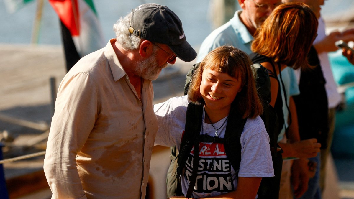 Swedish activist Greta Thunberg reacts with Irish actor Liam Cunningham as she arrives to take part in the Global Sumud Flotilla, a humanitarian expedition to Gaza, led by her and other activists, at the port of Barcelona, Spain, Aug. 31, 2025. (Reuters Photo)