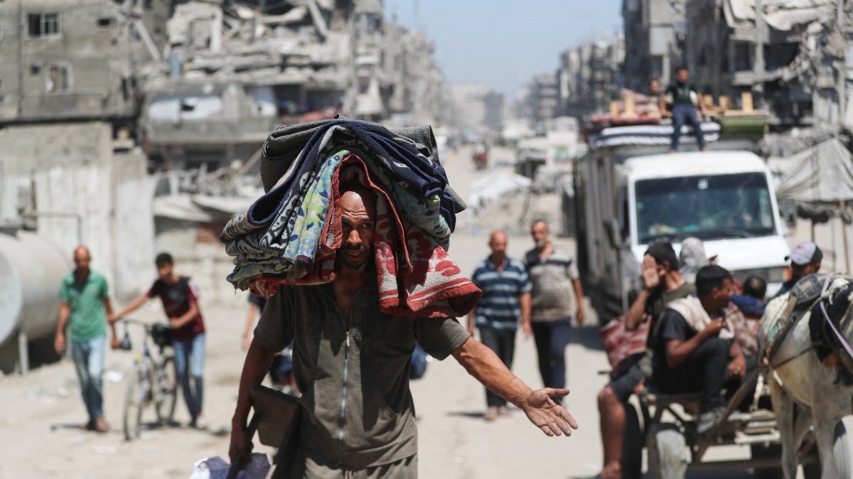 A displaced Palestinian carries belongings, as he flees amid an Israeli military operation, in Gaza City, Sept. 1, 2025. (Reuters Photo)