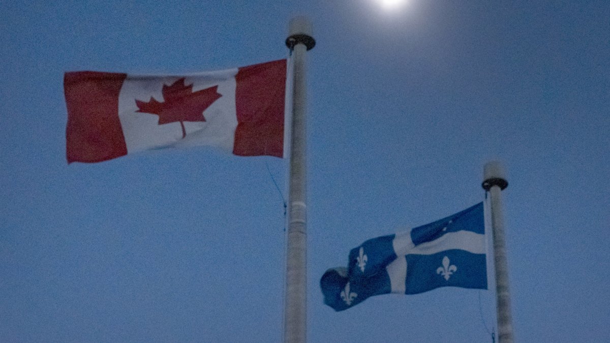 The moon covers the sun during a total solar eclipse, as Canadian and Quebec flags fly, as seen from Bishop's University in Sherbrooke, Quebec, Monday, April 8, 2024. (AP File Photo)