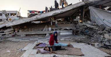 Two children sit on a blanket daily in their life, Khan Younis, southern Gaza Strip, Palestine, Aug. 30, 2025. (EPA Photo)