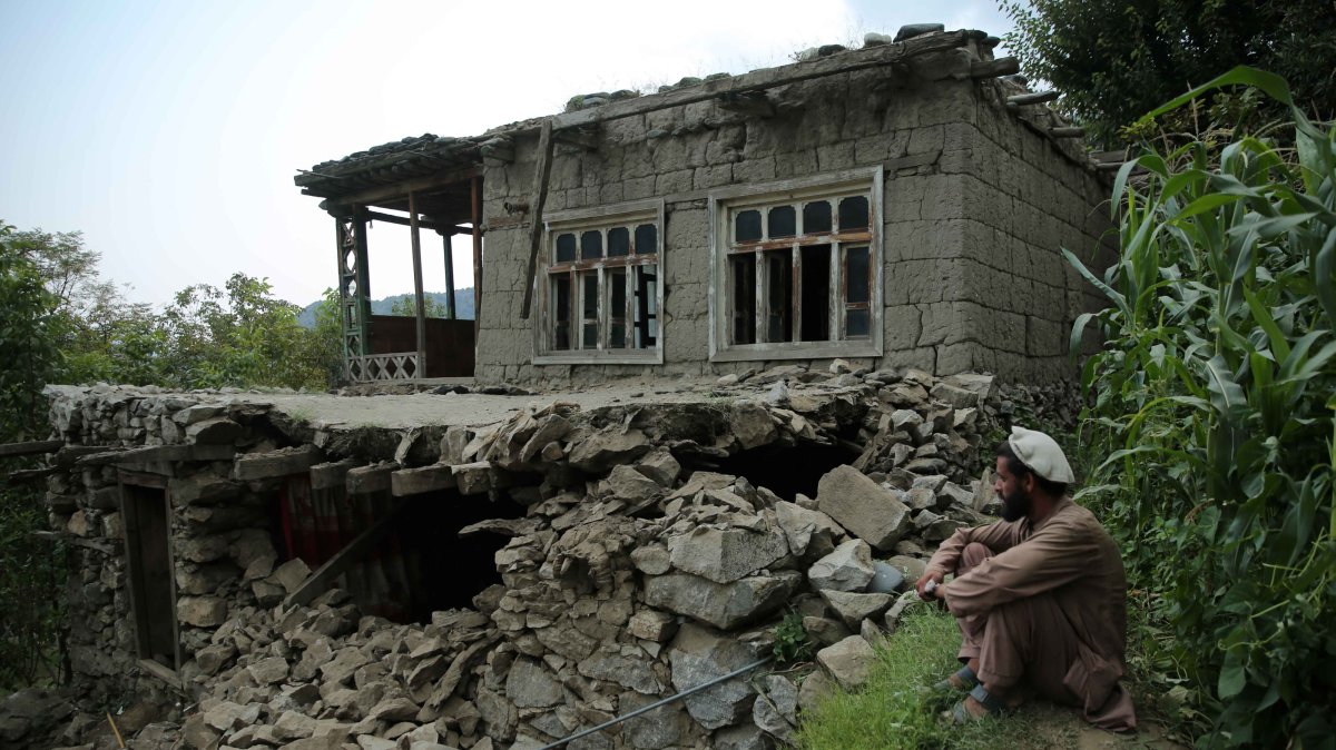 A man sits near a damaged house after an earthquake in Kunar, Afghanistan, Sept. 1, 2025. (EPA Photo)