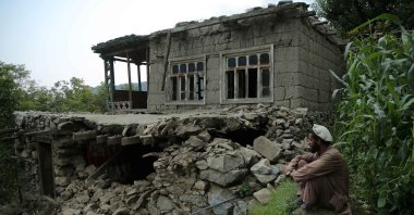 A man sits near a damaged house after an earthquake in Kunar, Afghanistan, Sept. 1, 2025. (EPA Photo)