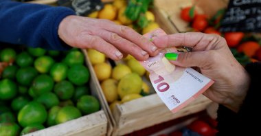A shopper pays with a 10 euro banknote at a local market, Aix-en-Provence, France, Jan. 16, 2025. (Reuters Photo)