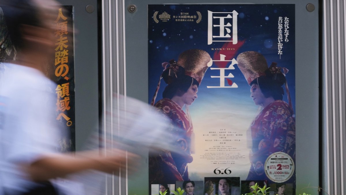 A person walks by a poster of film &quot;Kokuho,&quot; in Tokyo, Japan, Aug. 29, 2025. (AP Photo)
