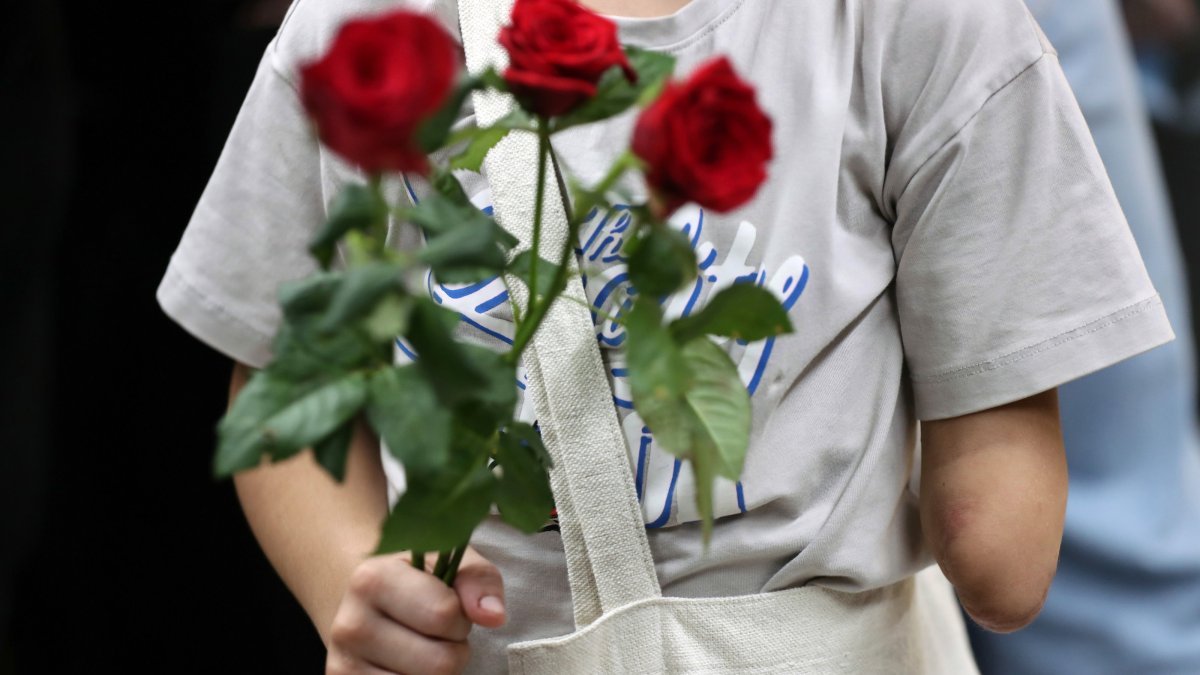 A Palestinian child holds flowers at Rafic Hariri International Airport for medical treatment in Beirut, Lebanon, Sept. 2, 2025. (EPA Photo)