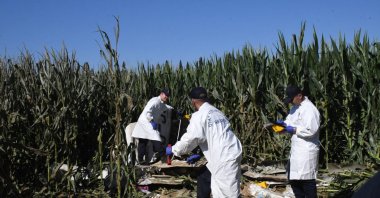Investigation teams examine the wreckage of the Cessna-172 training aircraft that crashed in a corn field, Izmir, Türkiye, Sept. 3, 2025. (AA Photo)