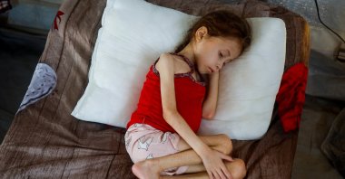 Jana Ayad, a malnourished Palestinian girl, rests on a bed as she receives treatment at the International Medical Corps field hospital, amid Israel&#039;s genocidal war, Deir Al-Balah, Gaza, Palestine, June 22, 2024. (Reuters Photo)