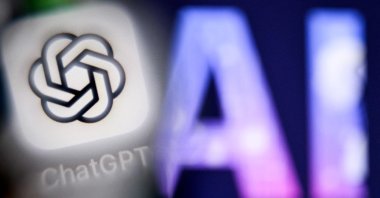 The letters “AI” are seen next to the ChatGPT logo on a smartphone in Frankfurt, Germany, Sept. 1, 2025. (AFP Photo)
