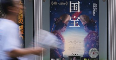 A person walks by a poster of film &quot;Kokuho,&quot; in Tokyo, Japan, Aug. 29, 2025. (AP Photo)