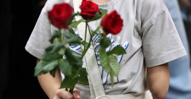 A Palestinian child holds flowers at Rafic Hariri International Airport for medical treatment in Beirut, Lebanon, Sept. 2, 2025. (EPA Photo)