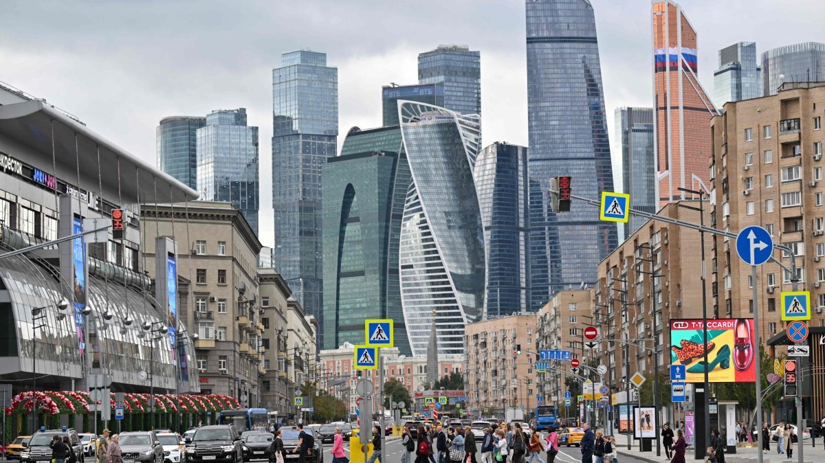 People cross a street in front of skyscrapers of the Moscow International Business Center in Moscow, Russia, Sept. 3, 2025. (AFP Photo)