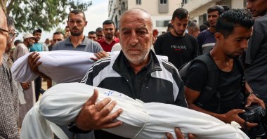 Palestinian men carry the shrouded bodies of children killed in Israeli strikes on Gaza City at dawn, during a funeral procession outside the Al-Shifa hospital, the Gaza Strip, Palestine, Sept. 4, 2025. (AFP Photo)