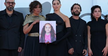 The director and cast of &quot;The Voice of Hind Rajab&quot; pose with a portrait of the late Palestinian girl Hind Rajab on the red carpet at the 82nd Venice International Film Festival, Venice, Italy, Sept. 3, 2025. (AFP Photo)