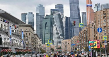 People cross a street in front of skyscrapers of the Moscow International Business Center in Moscow, Russia, Sept. 3, 2025. (AFP Photo)