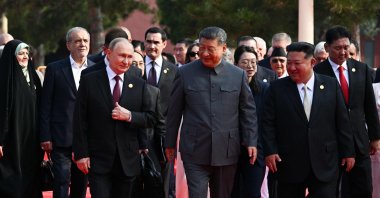 TOPSHOT - In this pool photograph distributed by the Russian state agency Sputnik, (L-R) Russia's President Vladimir Putin walks with China's President Xi Jinping and North Korea's leader Kim Jong Un before a military parade marking the 80th anniversary of victory over Japan and the end of World War II, in Beijing’s Tiananmen Square on September 3, 2025. (Photo by Sergey Bobylev / POOL / AFP)