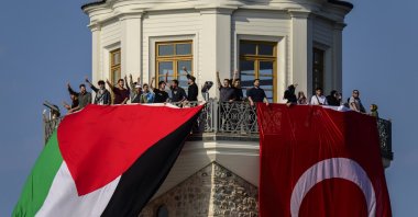 Turkish and Palestinian flags hang from the Maiden’s Tower during a pro-Gaza event organized by the Open Rafah movement on the Bosporus in Istanbul, Aug. 28, 2025. (AA File Photo)