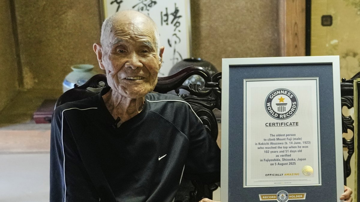 Kokichi Akuzawa, recently recognized by Guinness World Records as the oldest person to climb Mount Fuji (male), poses for a photo with his Guinness certificate, Maebashi, Tokyo, Sept. 3, 2025. (AP Photo)