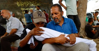 Relatives embrace a child victim, who is part of a group of Palestinians killed in overnight Israeli strikes during their funeral at Al-Shifa Hospital in Gaza City, Palestine, Sept. 5, 2025. (Reuters Photo)