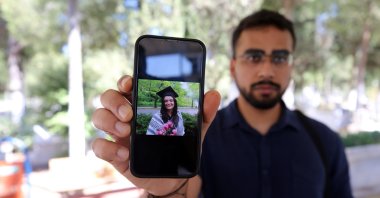 Ayşenur Ezgi Eygi&#039;s husband Hamid Ali holds up a picture of her during an interview with Anadolu Agency (AA) in Eygi&#039;s hometown Aydın, western Türkiye, Sept. 4, 2025. (AA Photo)