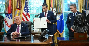US President Donald Trump (L) speaks as the Secretary of Defense Pete Hegseth and the Chairman of the Joint Chiefs of Staff Gen. Dan Caine (R) look on after signing executive orders in the Oval Office of the White House in Washington, D.C., Sept. 5, 2025. (AFP Photo)