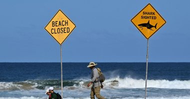 Residents walks along the shoreline as northern Sydney beaches are closed following a suspected shark attack at Long Reef Beach, Sydney, Australia, Sept. 6, 2025. (AFP Photo)