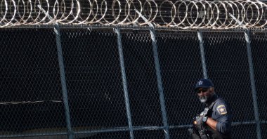 A police officer stands watch as activists protest outside of an Immigration and Customs Enforcement (ICE) facility in Broadview, Illinois, U.S., Sept. 5, 2025. (AFP Photo)