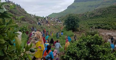 In this Monday, Sept. 1, 2025, photo provided by the Sudan Liberation Movement/Army, people gather at the site of a landslide from Aug. 31, that wiped out the village of Tarasin in the Marrah Mountains of Central Darfur, Sudan. (AP Photo)