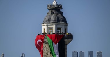 People unfurl Turkish and Palestinian flags in solidarity with Gaza at the Maiden&#039;s Tower, Istanbul, Türkiye, Aug. 23, 2025. (AA Photo)